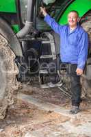 farmer standing in front of his tractor