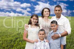 Hispanic Family Portrait Standing in Grass Field