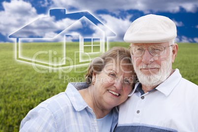 senior couple standing in grass field with ghosted house behind