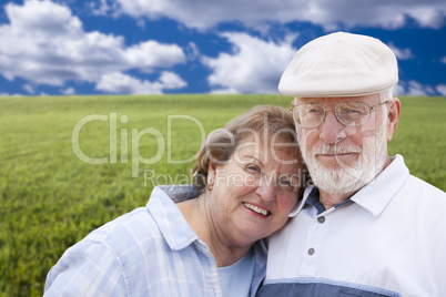 loving senior couple standing in grass field