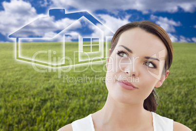woman and grass field with ghosted house figure behind