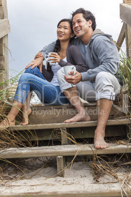 asian man woman romantic couple on beach steps