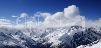 panorama of caucasus mountains in sunny clouds