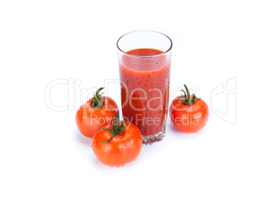 red tomatoes and glass of tomato juice on a white background