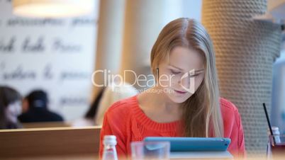 Woman in cafe with touchpad