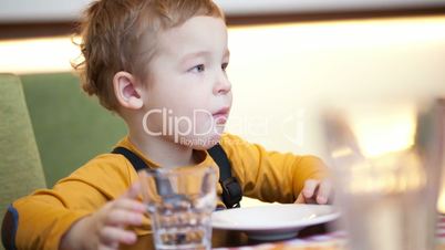 Boy at the table in cafe