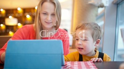 mother and her son with touchpad