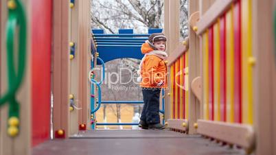 Little boy on playground equipment
