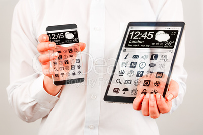 smartphone and tablet with transparent screen in human hands.