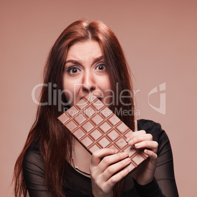 displeased young girl with the big chocolate