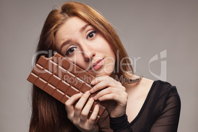 portrait of sad young girl with the big chocolate