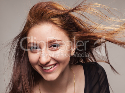close portrait of beautiful girl with fluttering hair.
