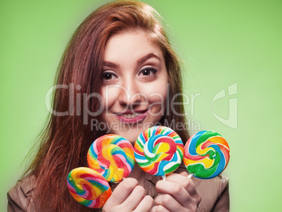 young girl with lollipop on a green