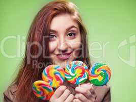 young girl with lollipop on a green