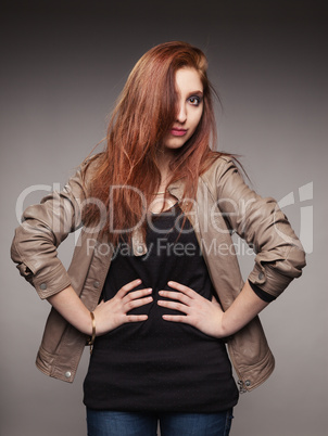 young red-haired girl in a leather jacket represents model