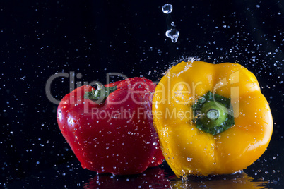red and yellow pepper in water