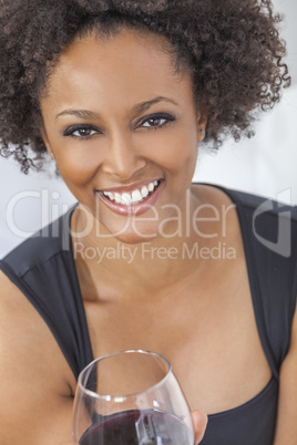 mixed race african american girl drinking red wine