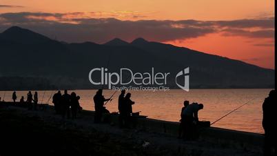silhouette fisherman throws fishing tackles at morning