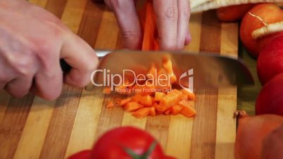 chopping carrot on a wooden board