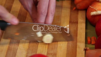 chopping parsnip on a wooden board