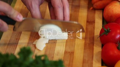 chopping onion on an wooden board