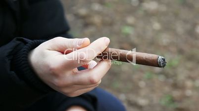 woman hand holding a cigar outdoor