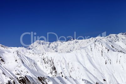winter snowy mountains and blue sky