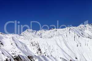 winter snowy mountains and blue sky
