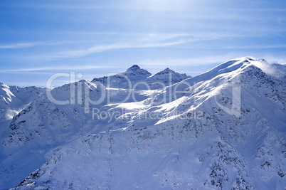 snowy sunlight mountains, view from off piste slope