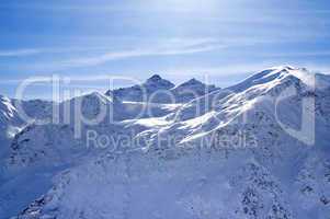snowy sunlight mountains, view from off piste slope