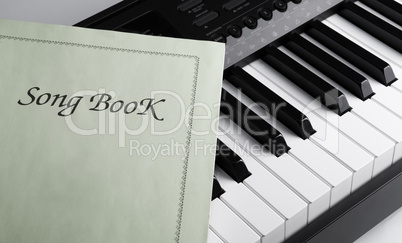 piano keys and song book