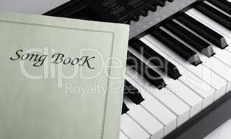 piano keys and song book