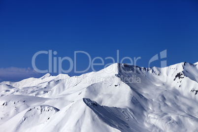 view on off-piste snowy slope at sunny day