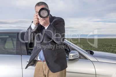 man standing in front of the car and photographed