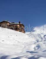 off-piste slope and hotel at sun day