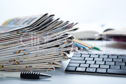 stack of newspapers and keyboard close-up