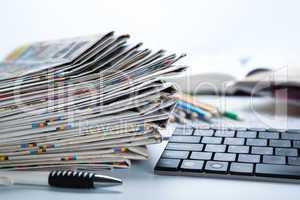 stack of newspapers and keyboard close-up