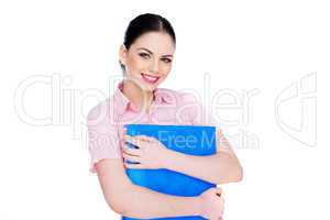 young woman smiling while holding a blue folder