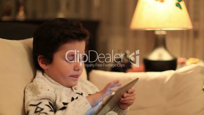 cute kid using tablet computer
