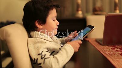 cute kid using tablet computer