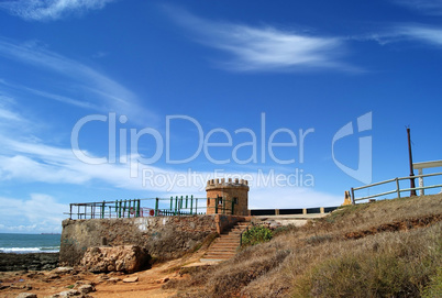 Ancient tower and fence onthe beach