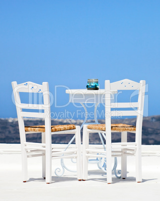 Two white chairs in santorini