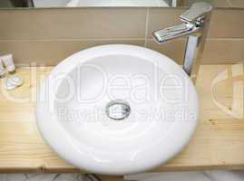 Round white sink in modern bathroom