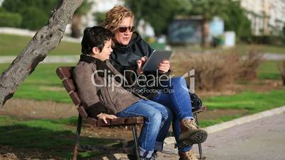 mother and son using tablet computer