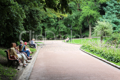 people have a rest in park with greater trees