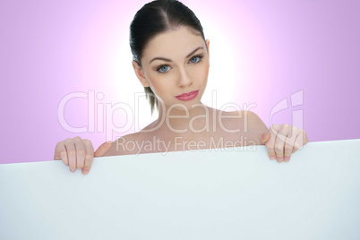 beautiful woman pointing to a blank sign