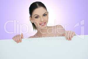 beautiful woman pointing to a blank sign