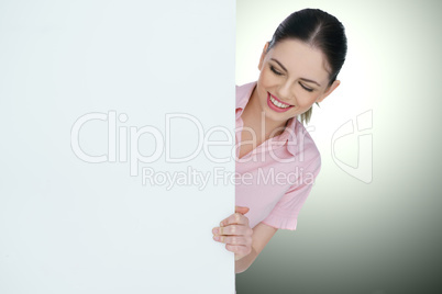 beautiful woman pointing to a blank sign