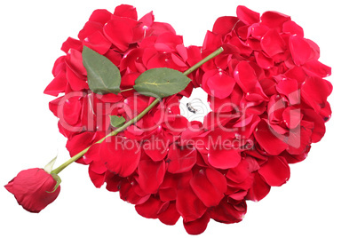 red rose petals in heart shape with rose arrow and diamond ring