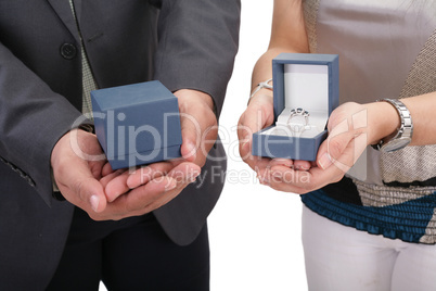 couple hands holding boxes with rings. valentines day and engage